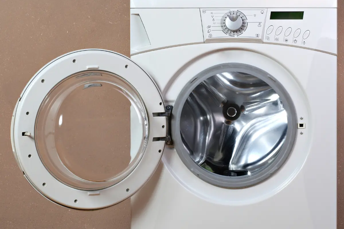 Washing machine against an brown wall