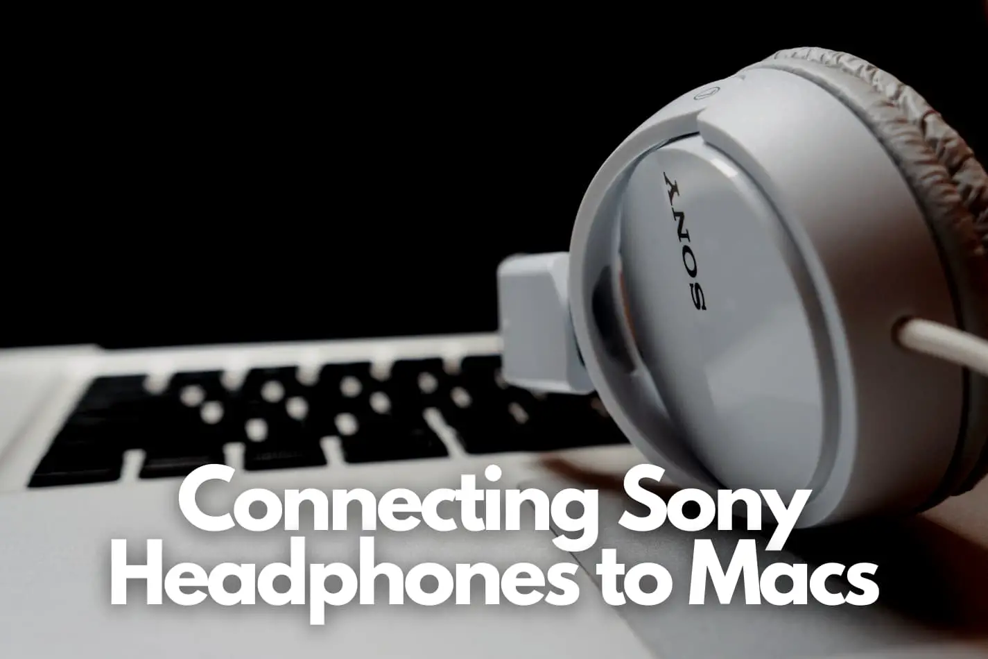Sony headphones laying on a macbook laptop