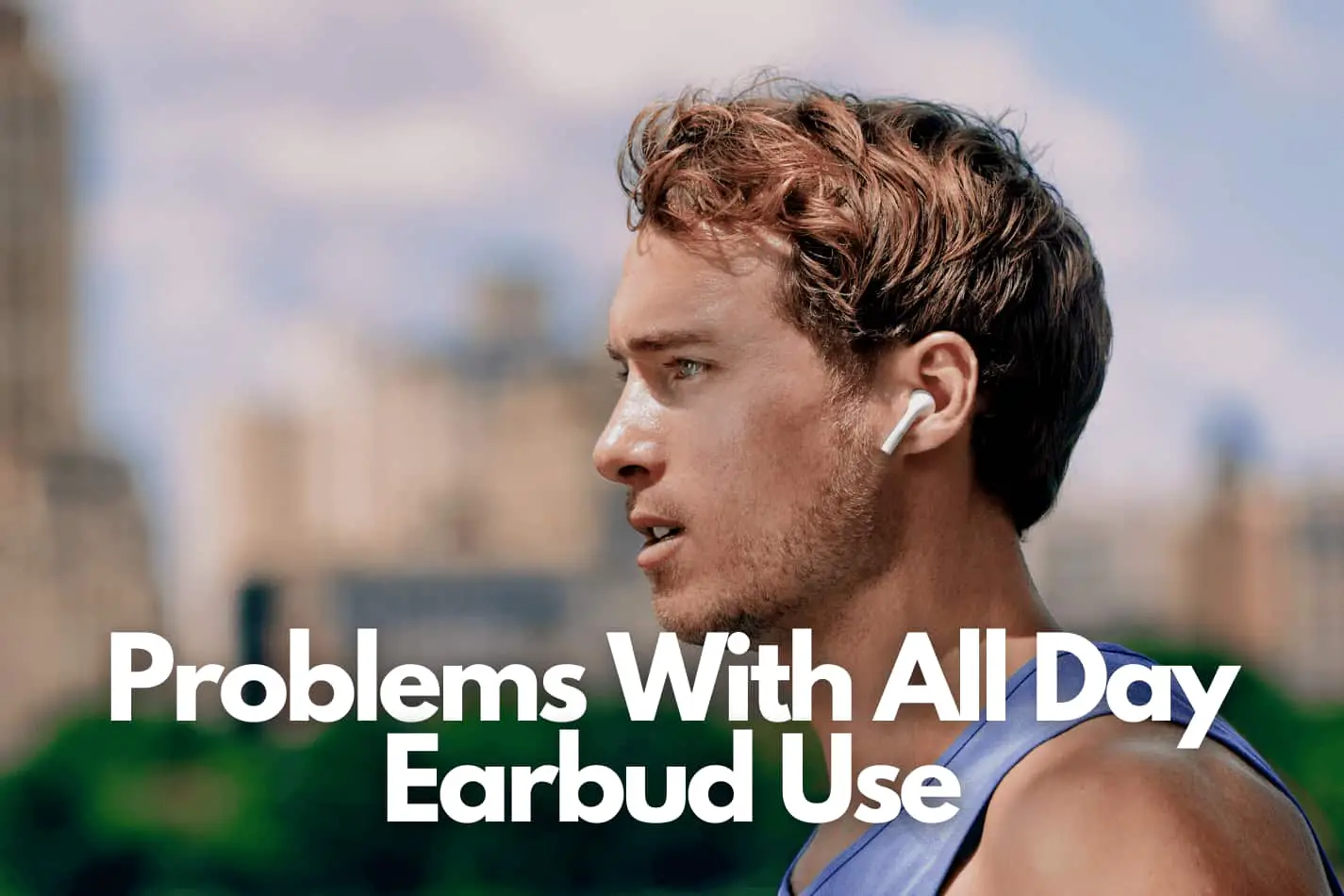 Athletic man wearing wireless earbuds in his ears while out in the city